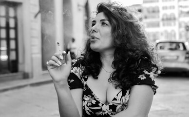 Bad habits in people's life. Addiction concept. Woman smoking cigarette in Italy