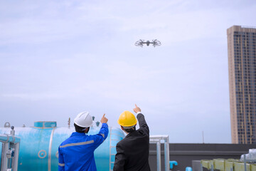 Engineers are checking HVAC system at rooftop.