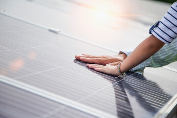 Father and daughter on a solar farm filled with solar panels. Solar energy for future generations Resource saving concept Electrical energy sources and alternative energy.