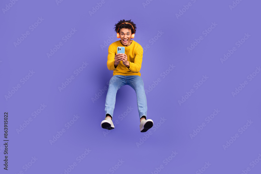 Canvas Prints photo of cheerful positive glad man wear trendy yellow clothes jump up isolated on purple color back