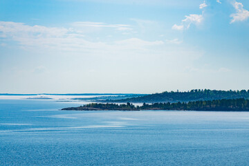 A picturesque forested island surrounded by the pristine blue waters of a tranquil lake. Perfect for nature and travel enthusiasts looking for a serene and natural landscape.