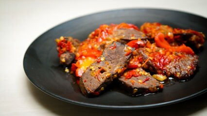 Lung beef (paru balado) cooked in spicy balado seasoning, which is sure to arouse appetite, selective focus and close up