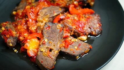 Lung beef (paru balado) cooked in spicy balado seasoning, which is sure to arouse appetite, selective focus and close up