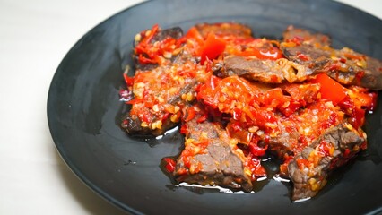 Lung beef (paru balado) cooked in spicy balado seasoning, which is sure to arouse appetite, selective focus and close up