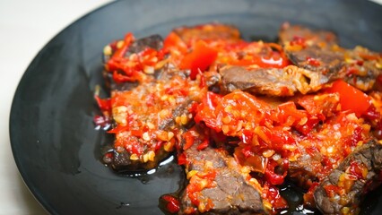 Lung beef (paru balado) cooked in spicy balado seasoning, which is sure to arouse appetite, selective focus and close up