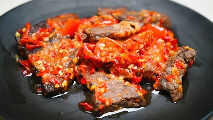 Lung beef (paru balado) cooked in spicy balado seasoning, which is sure to arouse appetite, selective focus and close up
