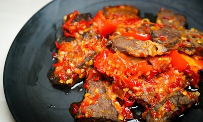 Lung beef (paru balado) cooked in spicy balado seasoning, which is sure to arouse appetite, selective focus and close up