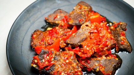 Lung beef (paru balado) cooked in spicy balado seasoning, which is sure to arouse appetite, selective focus and close up
