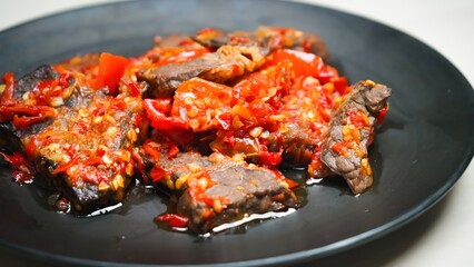 Lung beef (paru balado) cooked in spicy balado seasoning, which is sure to arouse appetite, selective focus and close up