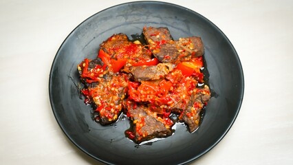 Lung beef (paru balado) cooked in spicy balado seasoning, which is sure to arouse appetite, selective focus and close up