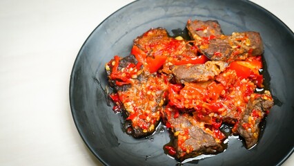 Lung beef (paru balado) cooked in spicy balado seasoning, which is sure to arouse appetite, selective focus and close up