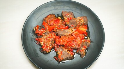 Lung beef (paru balado) cooked in spicy balado seasoning, which is sure to arouse appetite, selective focus and close up