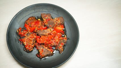 Lung beef (paru balado) cooked in spicy balado seasoning, which is sure to arouse appetite, selective focus and close up