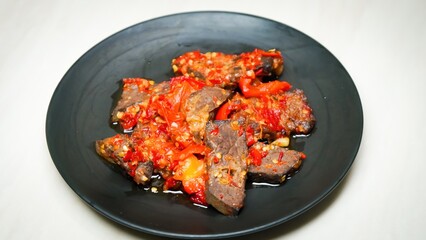 Lung beef (paru balado) cooked in spicy balado seasoning, which is sure to arouse appetite, selective focus and close up