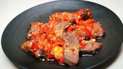 Lung beef (paru balado) cooked in spicy balado seasoning, which is sure to arouse appetite, selective focus and close up