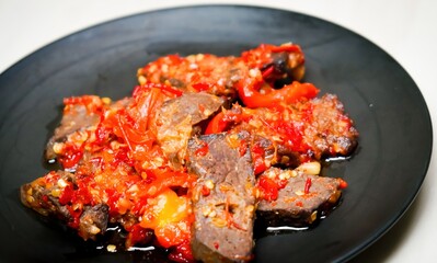 Lung beef (paru balado) cooked in spicy balado seasoning, which is sure to arouse appetite, selective focus and close up