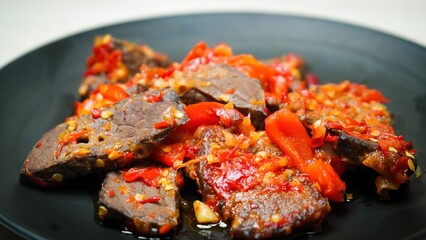 Lung beef (paru balado) cooked in spicy balado seasoning, which is sure to arouse appetite, selective focus and close up