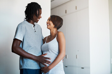 Naklejka premium Happy couple, pregnancy and tummy with maternity for expectation, start or family at home. Young man and pregnant woman with baby belly, hug or love for support, care or parenthood together at house