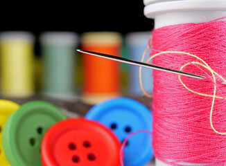 close-up needle and spool of thread