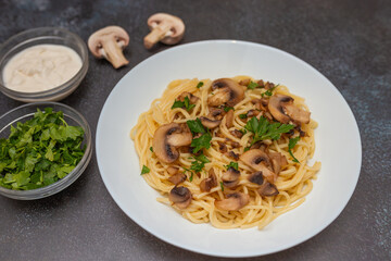 Mushroom Spaghetti Pasta and cream sauce on rustic, dark background, top view, copy space. Homemade italian pasta with champignon mushroom. 