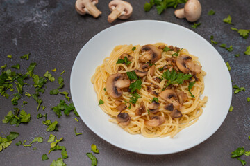 Mushroom Spaghetti Pasta and cream sauce on rustic, dark background, top view, copy space. Homemade italian pasta with champignon mushroom. 