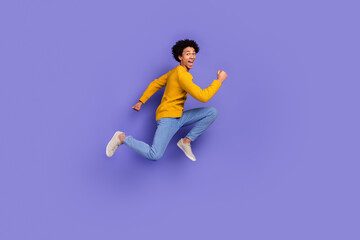 Photo of funky funny cheerful man wear trendy yellow clothes run empty space isolated on purple color background