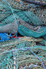 Nylon fishing nets in different colours and states of repair