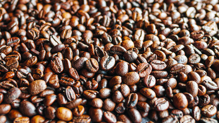 Close up of backdrop dark brown coffee beans and Textured background of freshly roasted coffee beans
