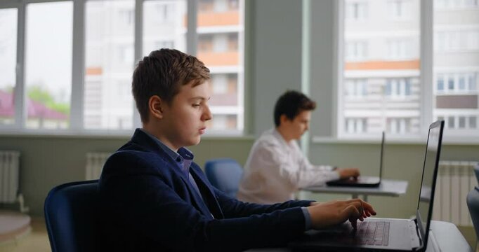 Caucasian Pupils Boys Working With Laptops In Computer-Based Class, Web-Design And Coding Classes
