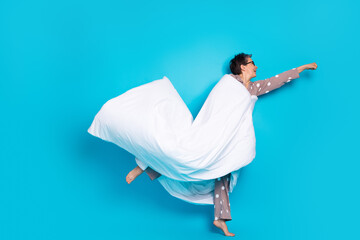 Naklejka premium Photo of crazy funny lovely senior woman wear stylish pajama fly empty space isolated on blue color background