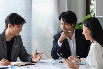 Diverse Team of Business Professionals Collaborating and Sharing Ideas in a Modern Office Setting