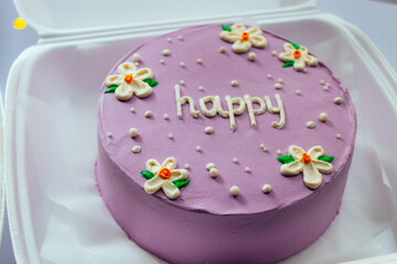 bento cake decorated with purple cream with daisies and the inscription 