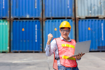 Happy Asian success professional male customs worker hand rising for in container port cargo shipping logistic industry.