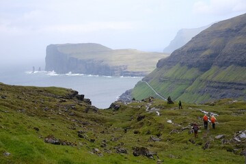 Mountain trip from Saksun village of Saksun to Tjornuvik on island of Streymoy. Silhouettes of...
