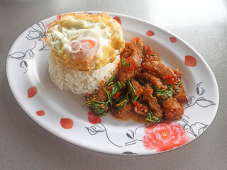 Rice topped with stir-fried pork and basil with fried egg