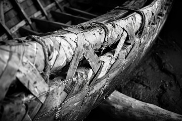Yaghan bark canoe, with emphasis on the intricate weaving of bark and wood, shot with soft, diffused lighting to accentuate the craftsmanship and historical significance