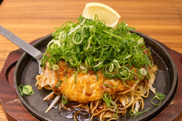 Japanese food okonomiyaki on a hot plate