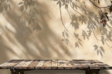 an empty wooden table top set against a beige wall for mockup photo