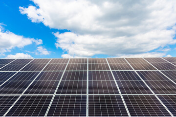 Obraz premium Solar panels horizontal shot on blue sky background. Ecological energy from a solar farm.
