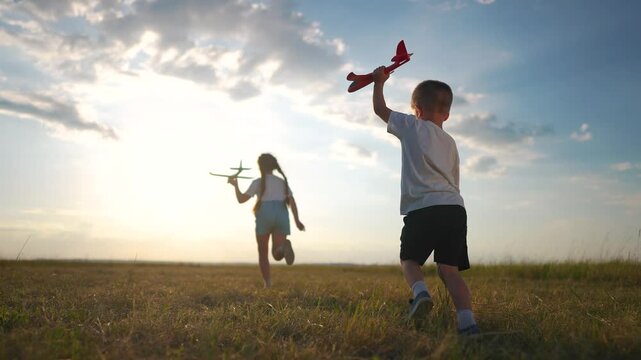 Plane is running through a forest with children in their childhood. Airplane toy field concept. plane parked next to crowd of children running. Child runs fun past plane parked park and runs around.