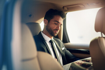 Car, newspaper and businessman reading in a taxi for travel, trip or commute in a city. Transport, cab or entrepreneur checking news for job search information in chauffeur service on journey outdoor