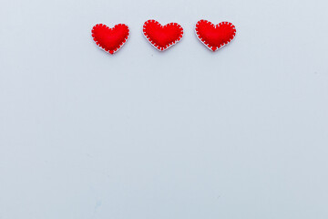 background of hearts of felt and two red hearts.