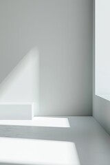 Obraz premium Modern room with minimalist design. Clean, light gray walls and floor create a spacious feel. Sunlight through window casts subtle shadows