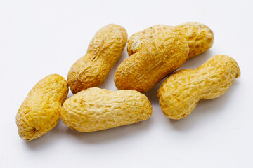 Roasted peanuts in shell on white background.