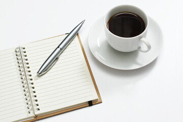 Notebook, pen and cup of coffee