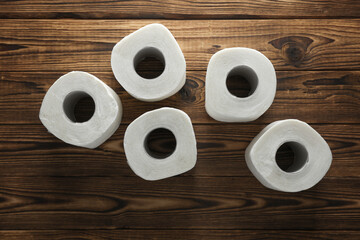 Lots of toilet paper rolls on wooden boards. Top view