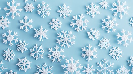 A close-up photograph showcasing white snowflakes delicately scattered on a soft blue background, highlighting their intricate and symmetrical beauty