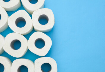 Lots of toilet paper rolls on blue background. Top view