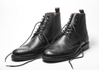 Stylish black leather men's brogue boots with untied laces on a white background