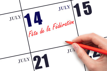 July 14. Hand writing text Festival of the Federation on calendar date. Save the date.